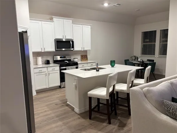 a dining room with furniture and wooden floor