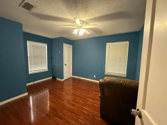a view of a livingroom with a window and wooden floor