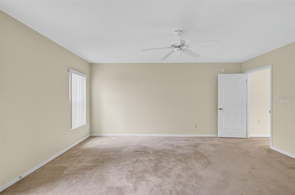 11353 Southwest 138th Lane Dunnellon, FL 34432 - Photo 21 of 33 a view of an empty room and a ceiling fan