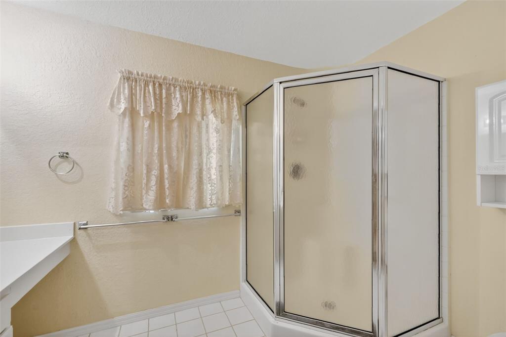 11353 Southwest 138th Lane Dunnellon, FL 34432 - Photo 23 of 33 a bathroom with a shower and a glass door