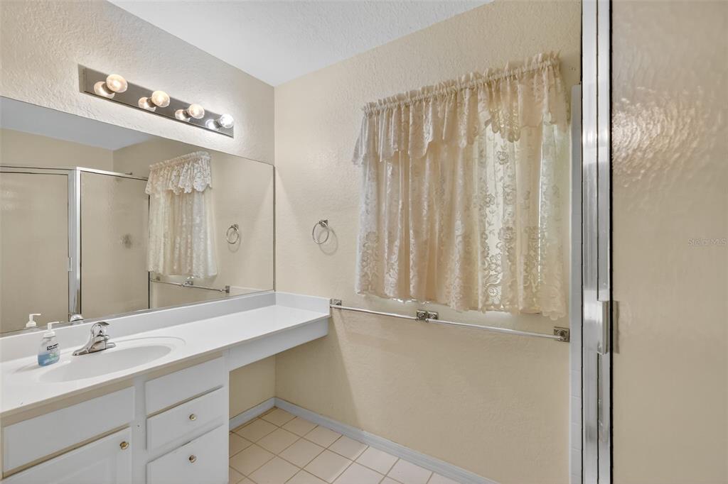 11353 Southwest 138th Lane Dunnellon, FL 34432 - Photo 24 of 33 a bathroom with a double vanity sink and a mirror