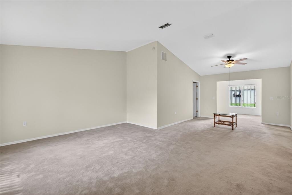 11353 Southwest 138th Lane Dunnellon, FL 34432 - Photo 7 of 33 a view of an empty room with windows and ceiling fan