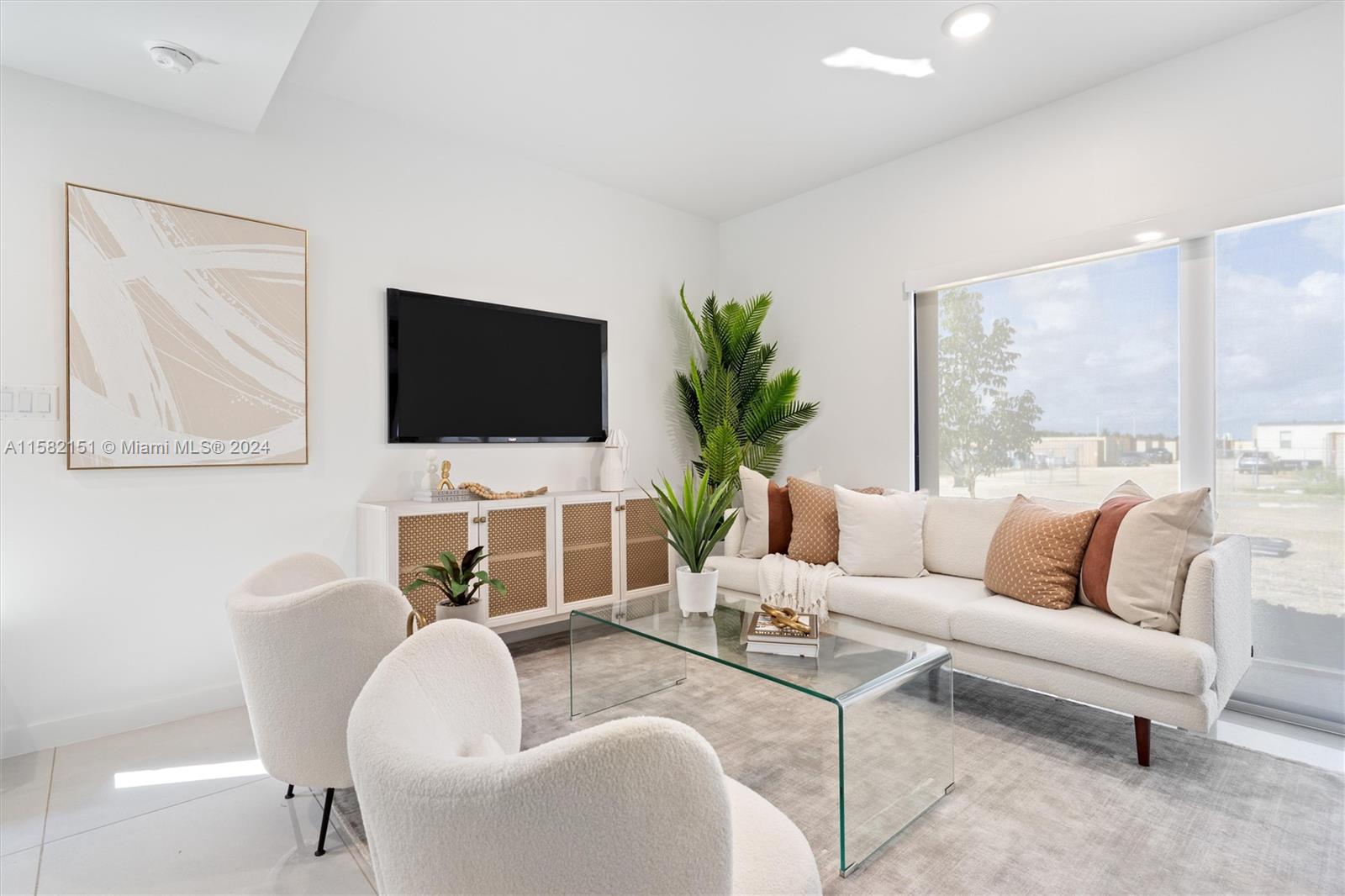214 Northwest 13th Street Florida City, FL 33034 - Photo 11 of 31 a living room with furniture a flat screen tv and a large window