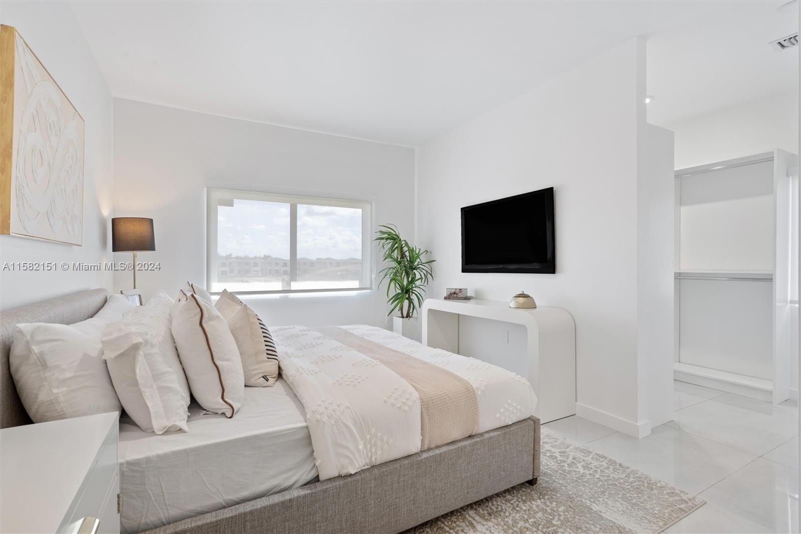 214 Northwest 13th Street Florida City, FL 33034 - Photo 14 of 31 a bedroom with a bed and a flat screen tv