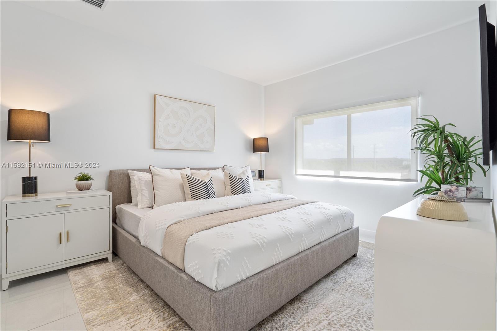 214 Northwest 13th Street Florida City, FL 33034 - Photo 15 of 31 a bedroom with bed and a potted plant