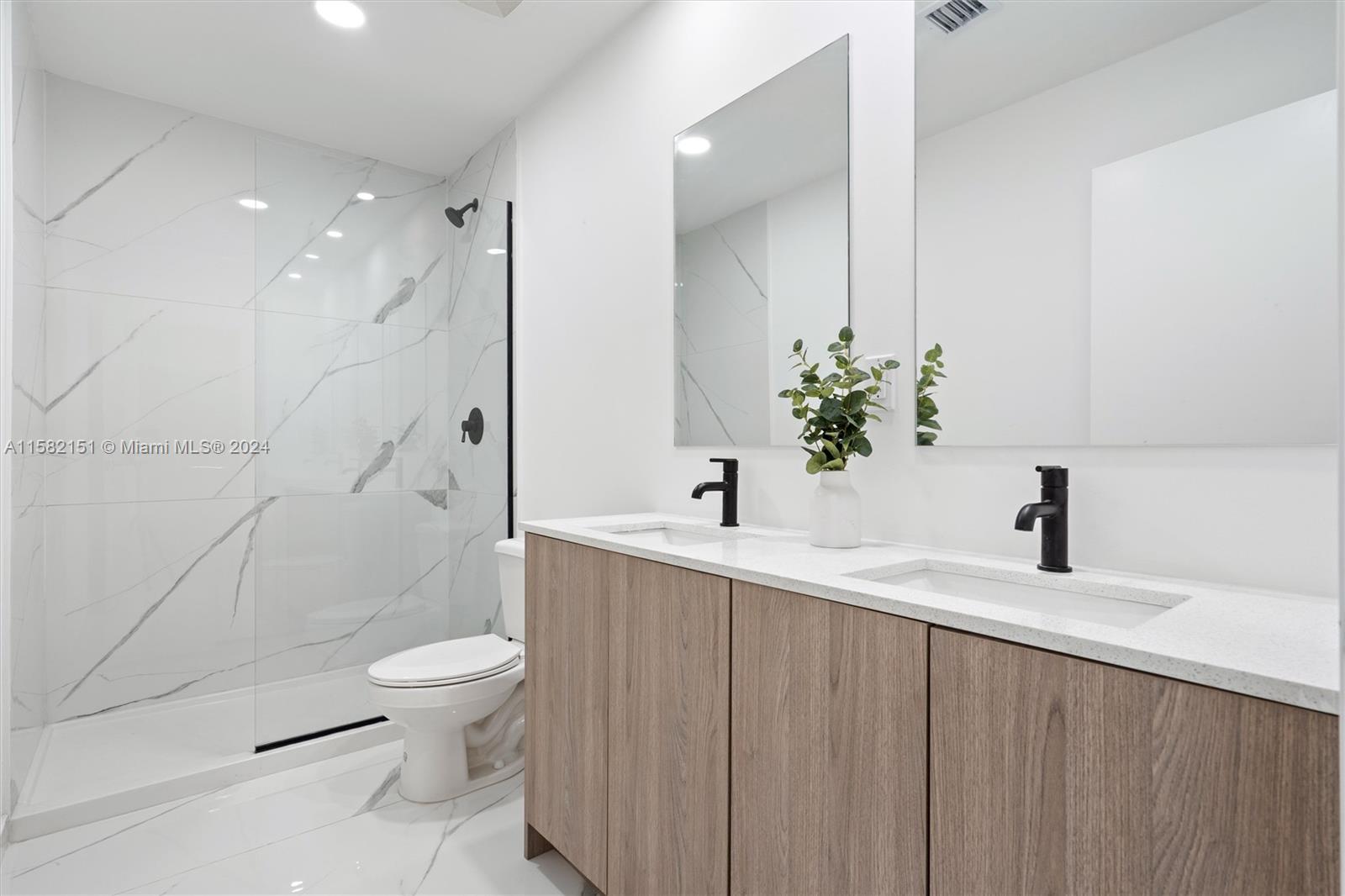 214 Northwest 13th Street Florida City, FL 33034 - Photo 17 of 31 a bathroom with a sink a toilet and shower