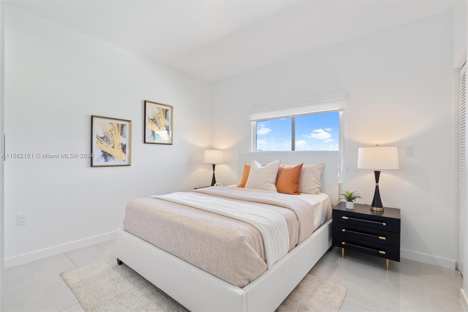 214 Northwest 13th Street Florida City, FL 33034 - Photo 18 of 31 a bedroom with a bed and a lamp