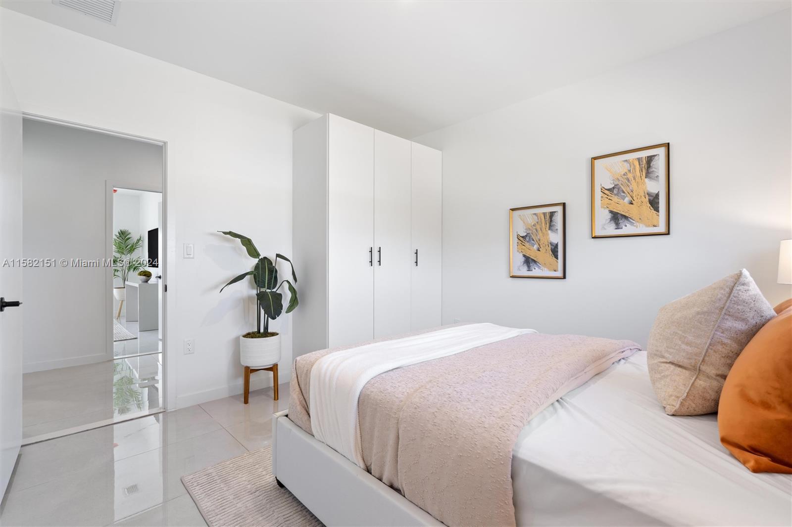 214 Northwest 13th Street Florida City, FL 33034 - Photo 19 of 31 a bedroom with a bed and a painting on the wall