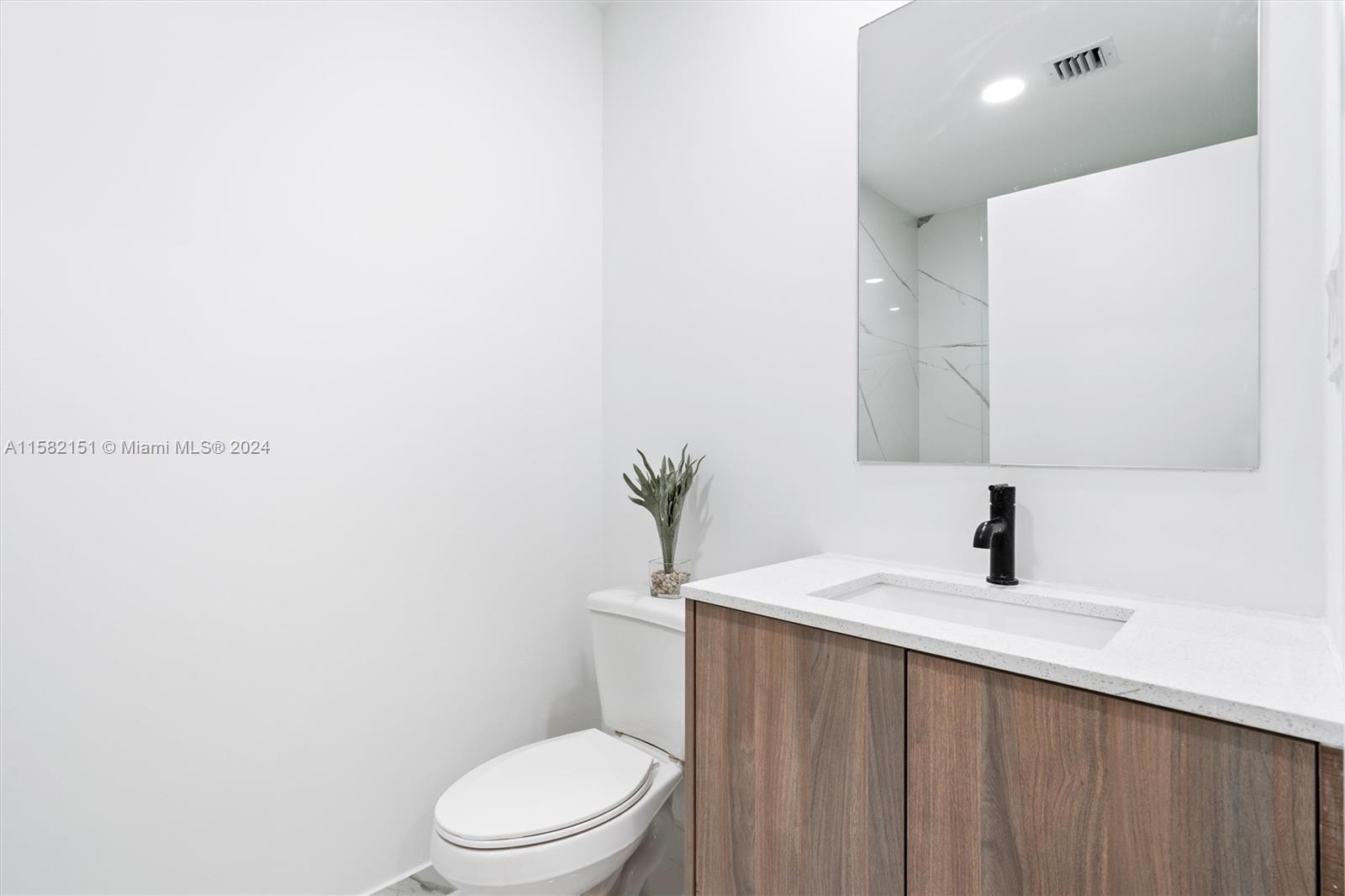 214 Northwest 13th Street Florida City, FL 33034 - Photo 20 of 31 a bathroom with a sink a toilet and mirror