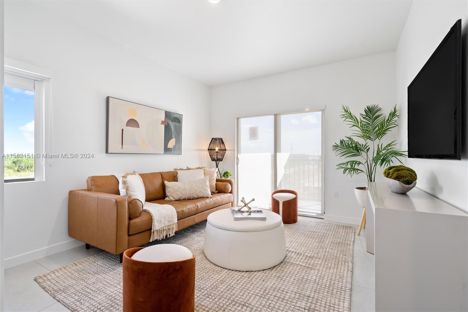 214 Northwest 13th Street Florida City, FL 33034 - Photo 22 of 31 a living room with furniture a flat screen tv and a potted plant