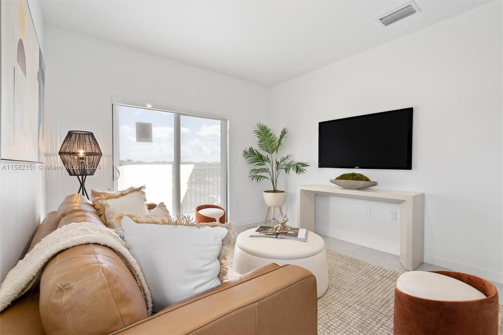 214 Northwest 13th Street Florida City, FL 33034 - Photo 23 of 31 a living room with furniture and a flat screen tv