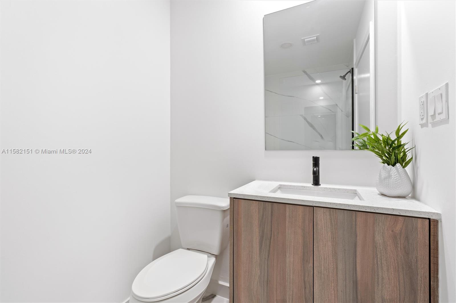 214 Northwest 13th Street Florida City, FL 33034 - Photo 24 of 31 a bathroom with a granite countertop sink vanity mirror and toilet