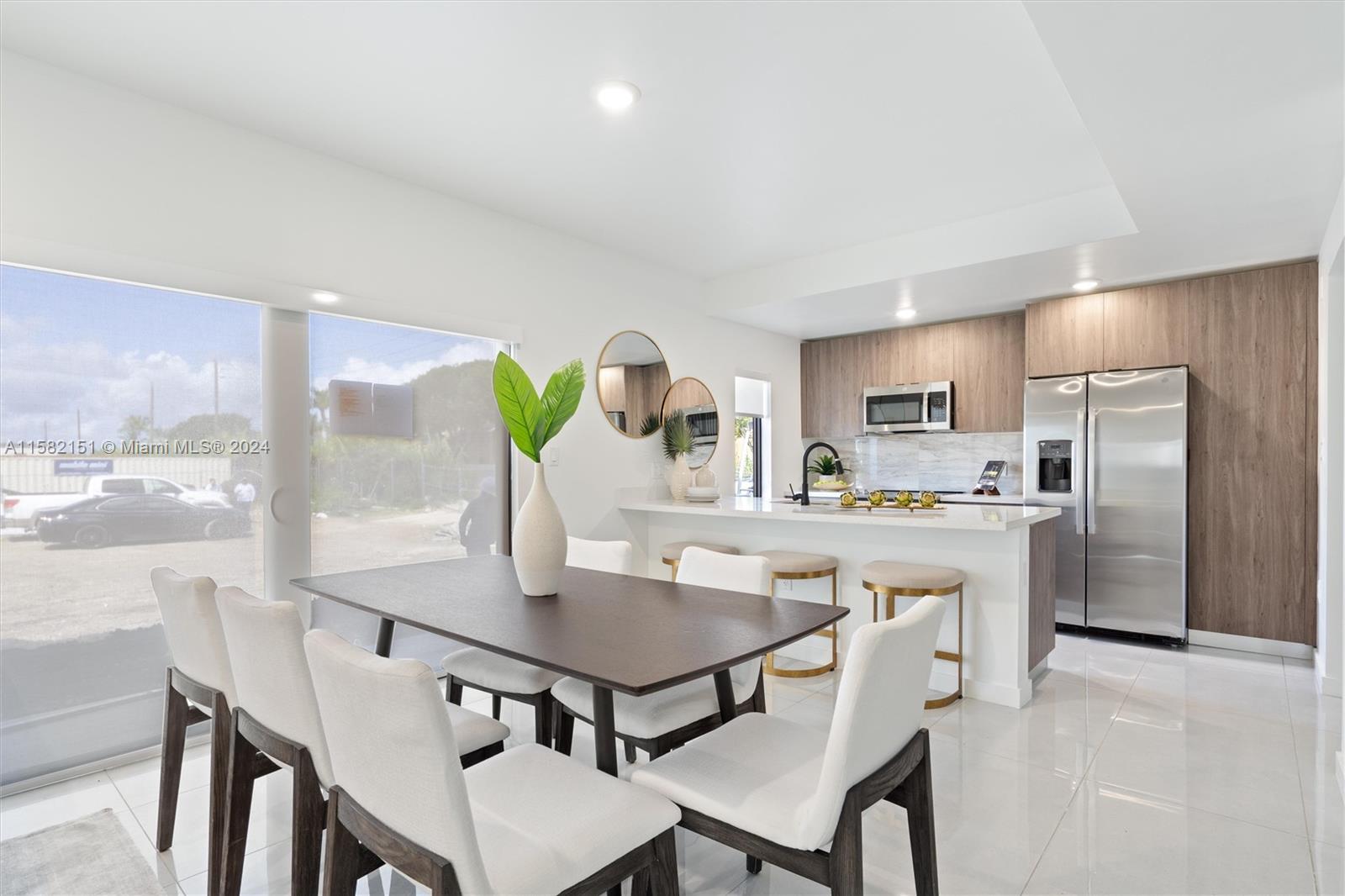 214 Northwest 13th Street Florida City, FL 33034 - Photo 7 of 31 a kitchen with stainless steel appliances a dining table chairs and a refrigerator
