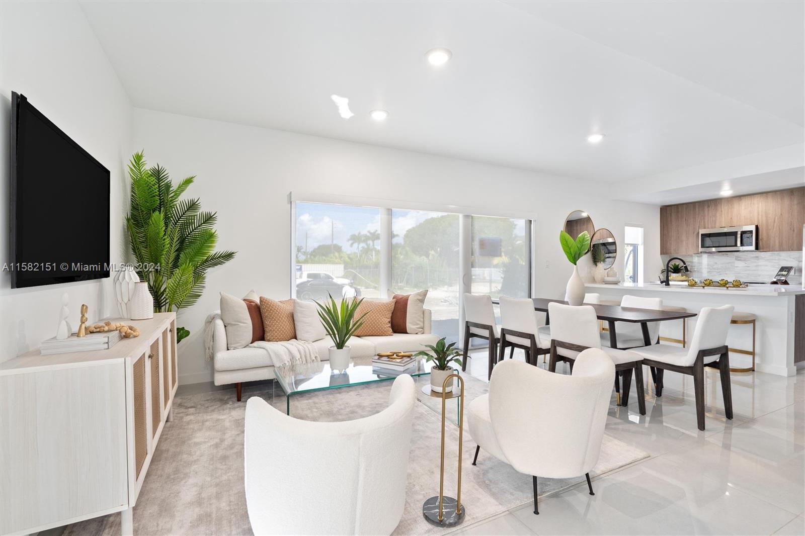 214 Northwest 13th Street Florida City, FL 33034 - Photo 9 of 31 a living room with furniture a flat screen tv and a large window