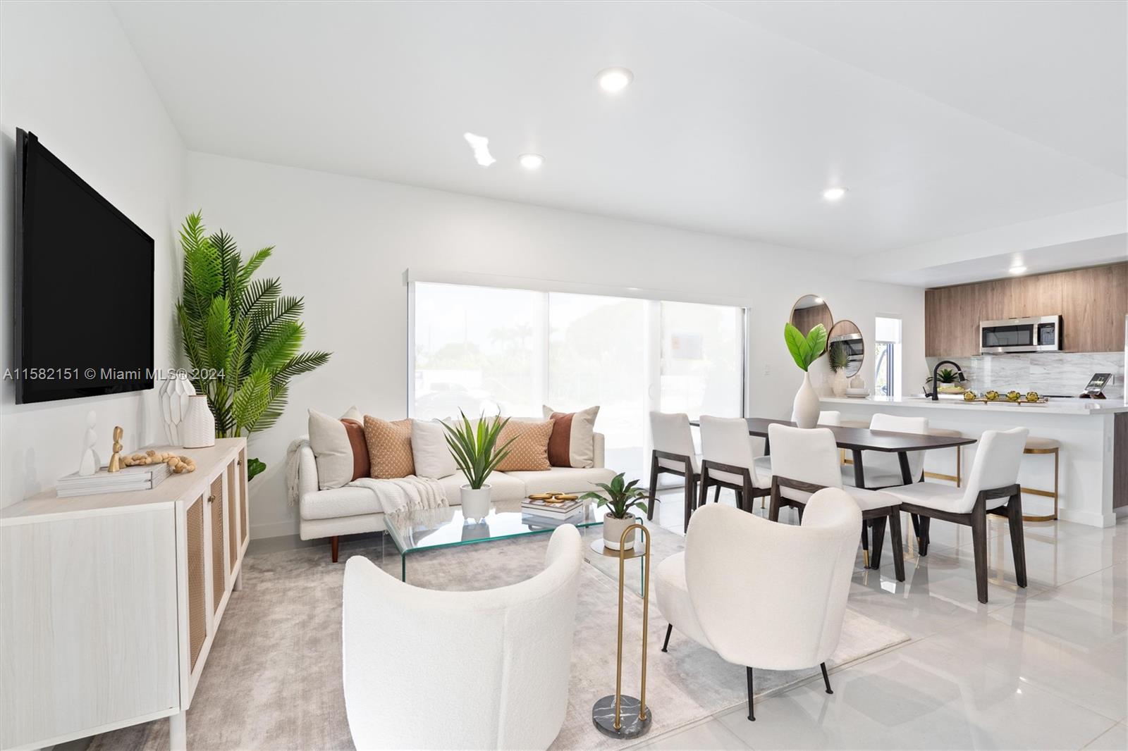 214 Northwest 13th Street Florida City, FL 33034 - Photo 10 of 31 a living room with furniture a flat screen tv and a large window