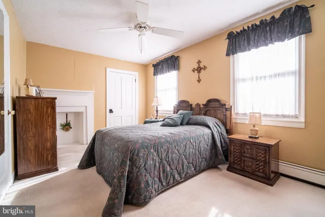 a bedroom with a bed dresser and a window