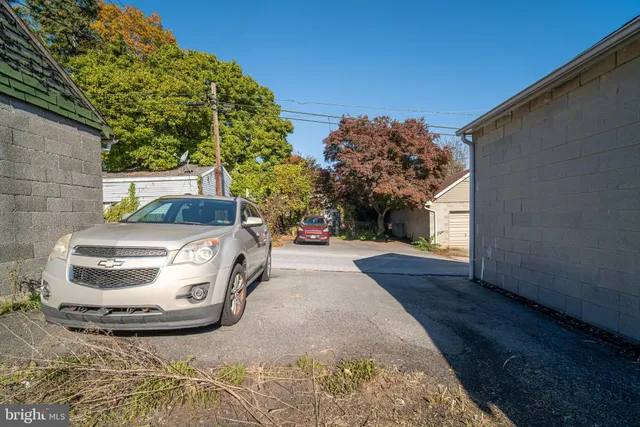 a view of a houses with cars