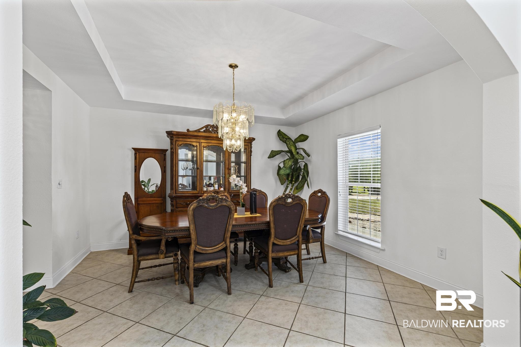 32875 Faircloth Road Lillian, AL 36549 - Photo 20 of 85 Dining area featuring a raised ceiling, hanging lights, and light tile patterned floors