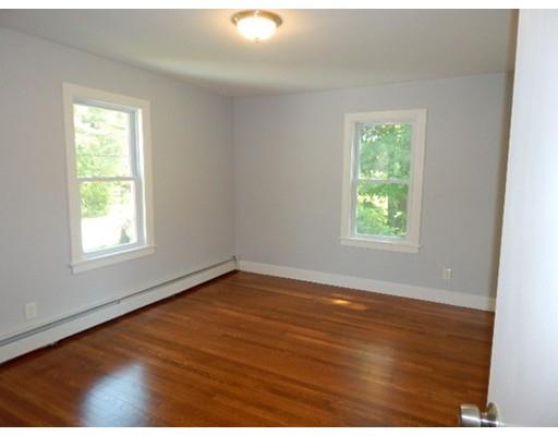 296 Great Road Shirley, MA 01464 - Photo 13 of 22 an empty room with wooden floor and windows