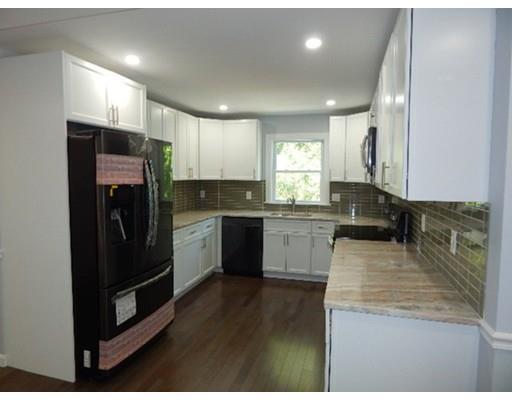 296 Great Road Shirley, MA 01464 - Photo 8 of 22 a kitchen with a refrigerator a sink a stove a microwave and cabinets