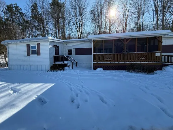 a view of backyard with deck and outdoor seating