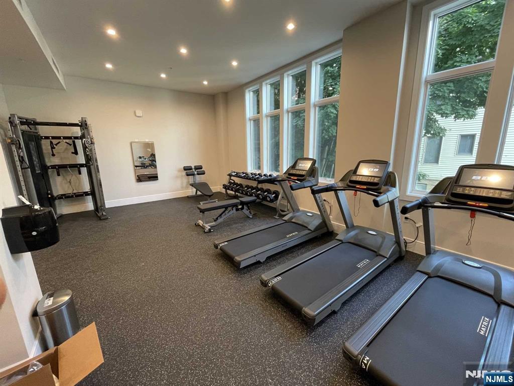 470 Main Street, Unit 703 Fort Lee, NJ 07024 - Photo 17 of 19 a room with gym equipment and a large window