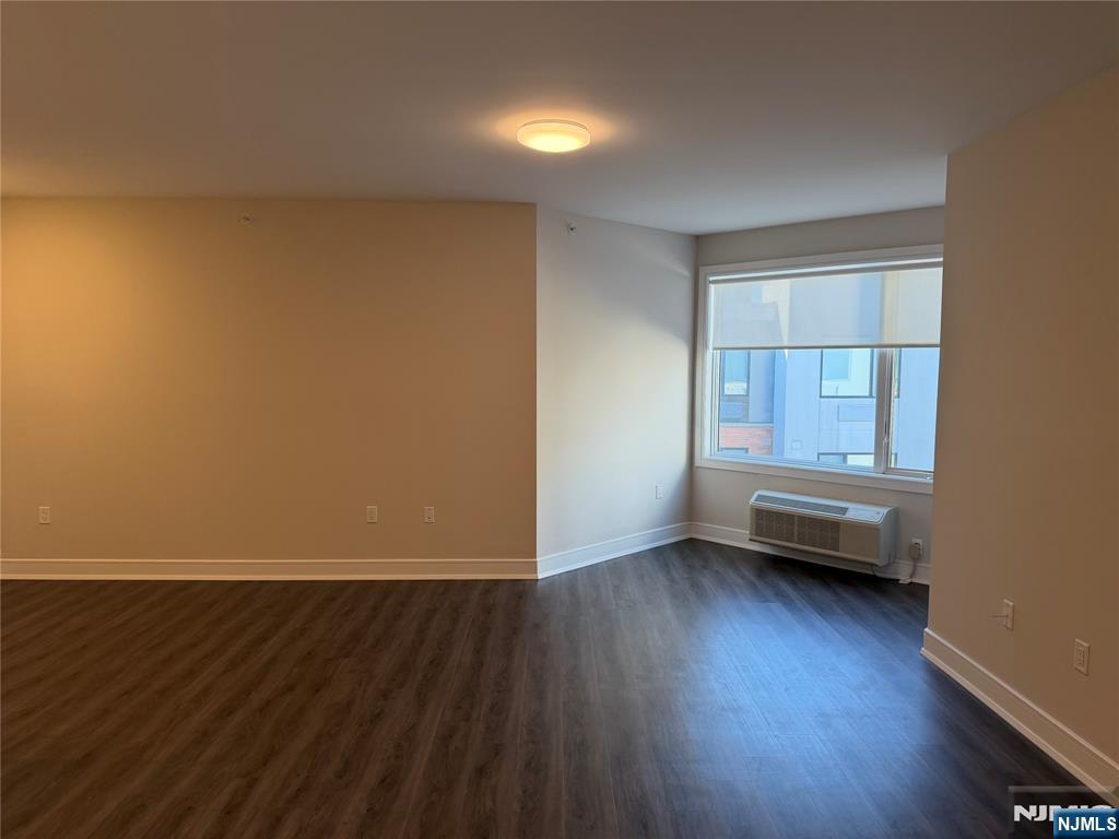 470 Main Street, Unit 703 Fort Lee, NJ 07024 - Photo 5 of 19 an empty room with wooden floor and windows