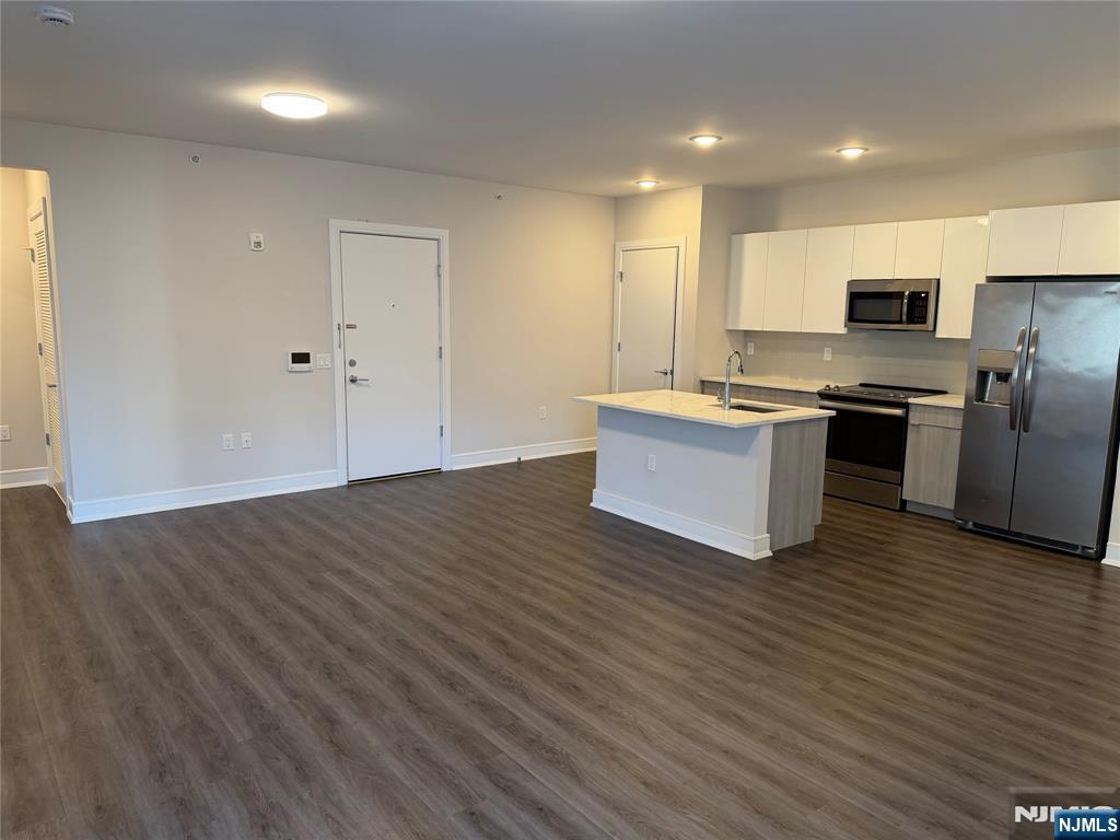 470 Main Street, Unit 703 Fort Lee, NJ 07024 - Photo 6 of 19 a view of kitchen with stainless steel appliances wooden floor and large window