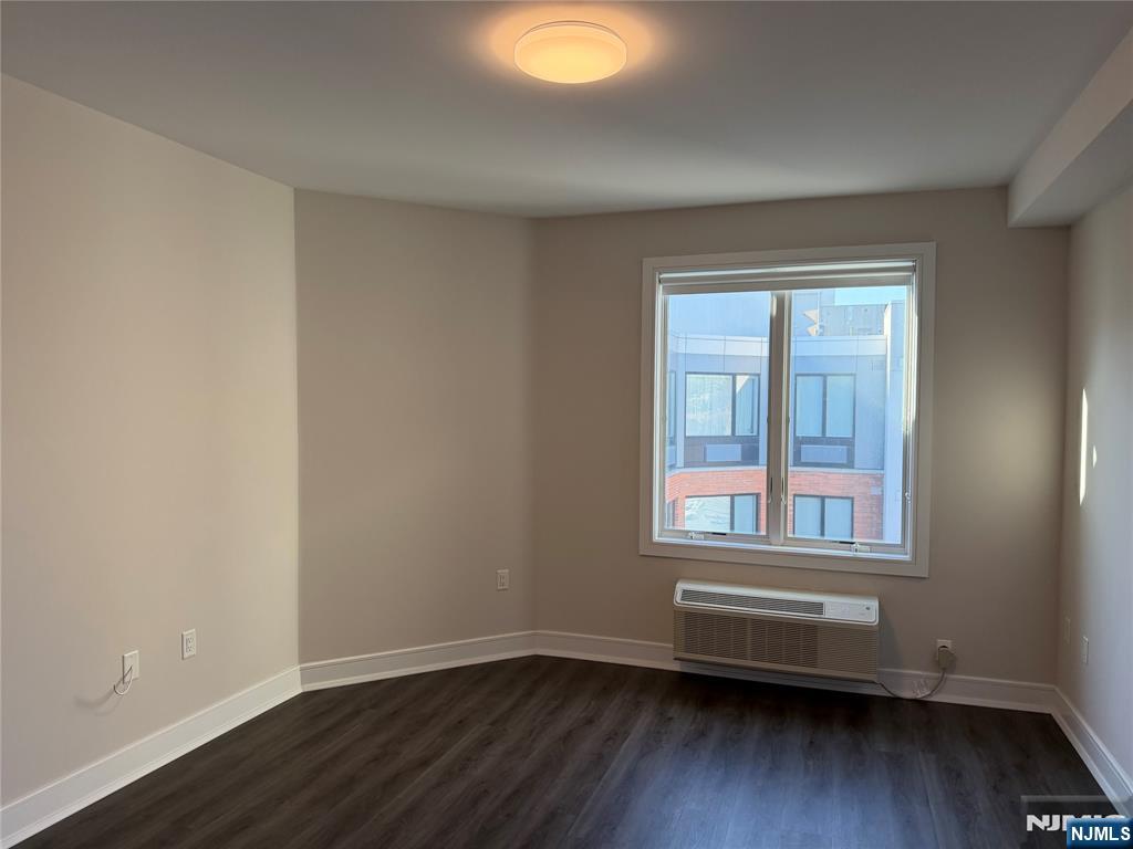 470 Main Street, Unit 703 Fort Lee, NJ 07024 - Photo 7 of 19 a view of an empty room with wooden floor and a window