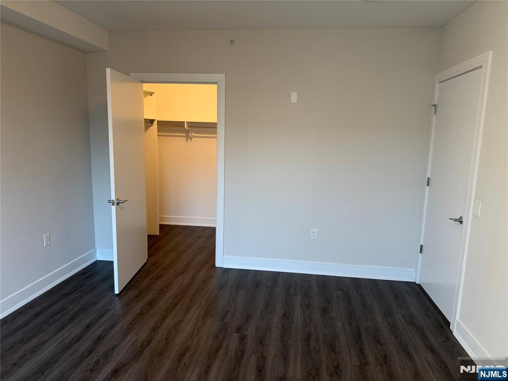 470 Main Street, Unit 703 Fort Lee, NJ 07024 - Photo 8 of 19 an empty room with wooden floor and windows