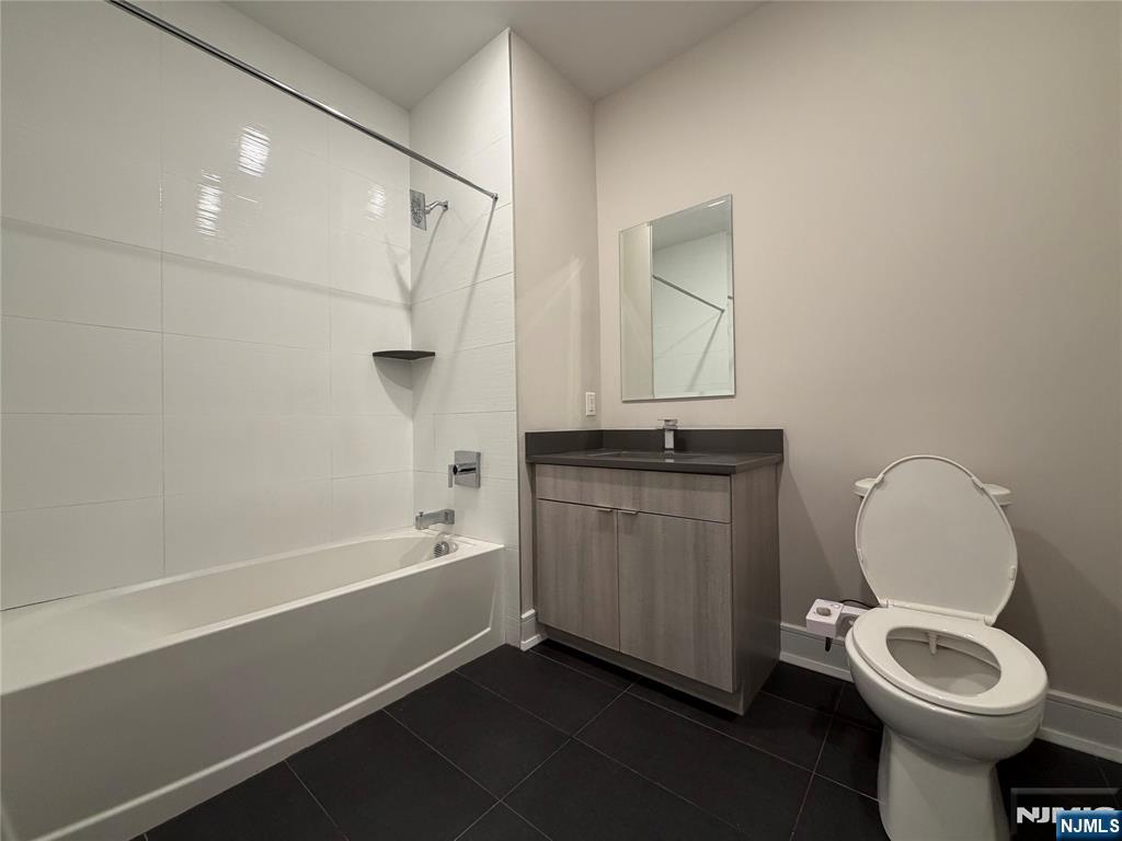 470 Main Street, Unit 703 Fort Lee, NJ 07024 - Photo 10 of 19 a bathroom with a granite countertop sink toilet and shower