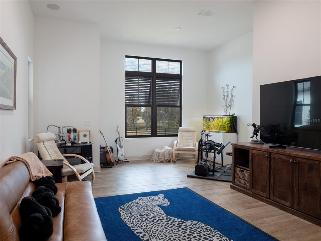 11920 Southeast 22nd Ave Road Ocala, FL 34480 - Photo 15 of 31 a living room with furniture and a flat screen tv