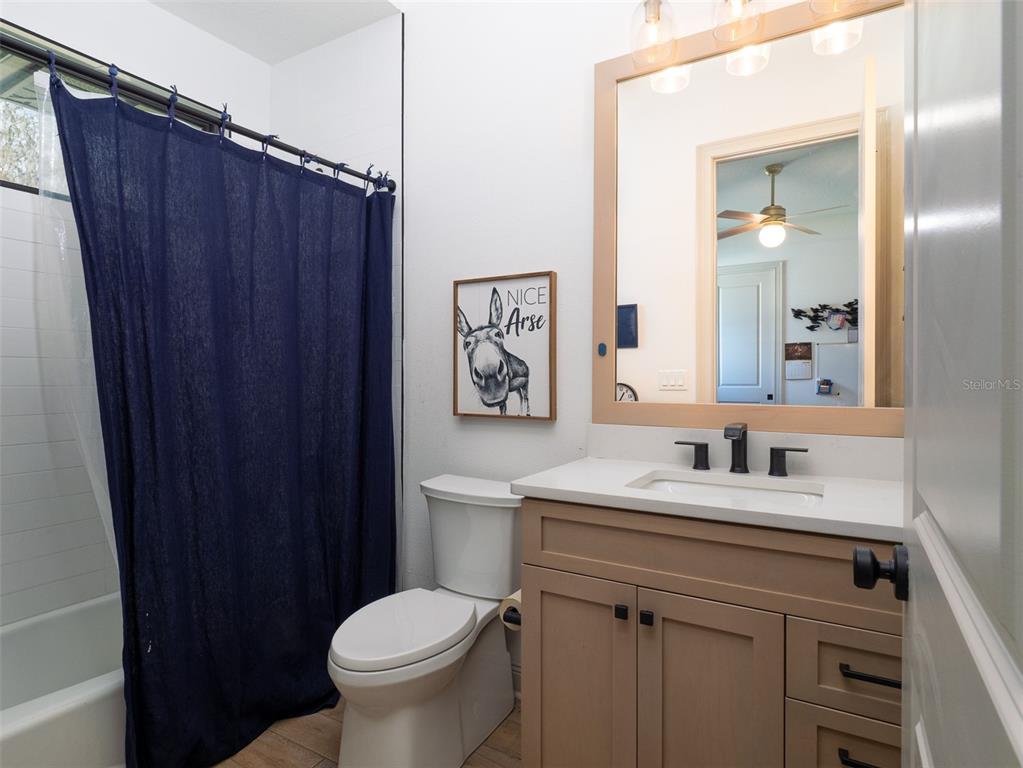 11920 Southeast 22nd Ave Road Ocala, FL 34480 - Photo 19 of 31 a bathroom with a toilet sink vanity and mirror