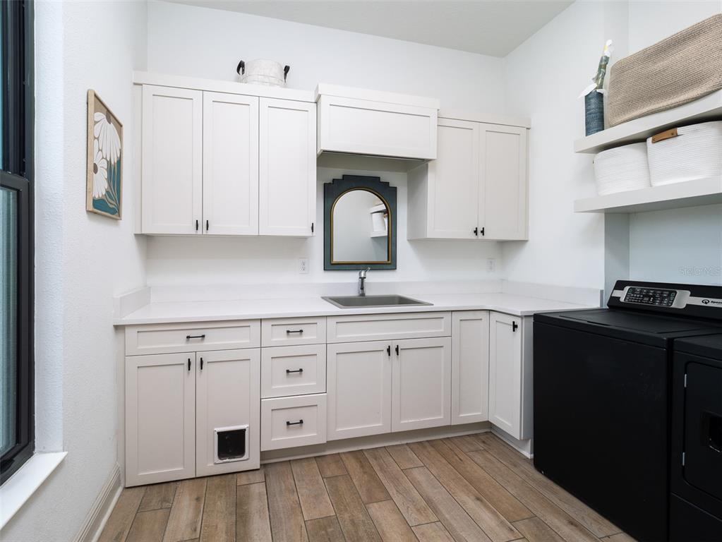 11920 Southeast 22nd Ave Road Ocala, FL 34480 - Photo 21 of 31 a kitchen with granite countertop white cabinets and black appliances