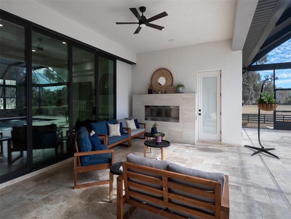 11920 Southeast 22nd Ave Road Ocala, FL 34480 - Photo 22 of 31 a living room with furniture a floor to ceiling window and potted plant