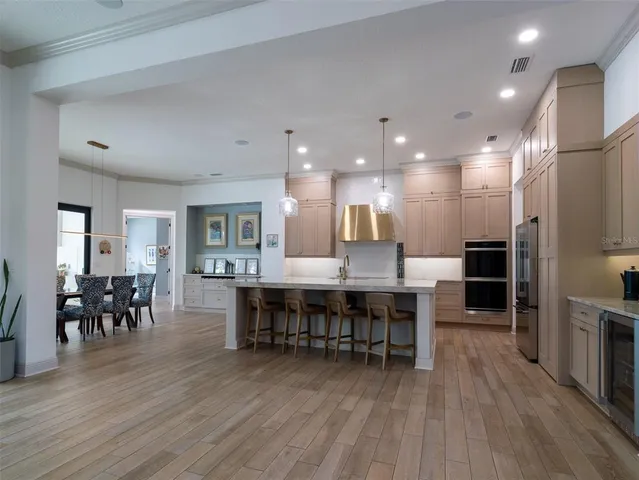 a view of a dining room with furniture wooden floor and chandelier