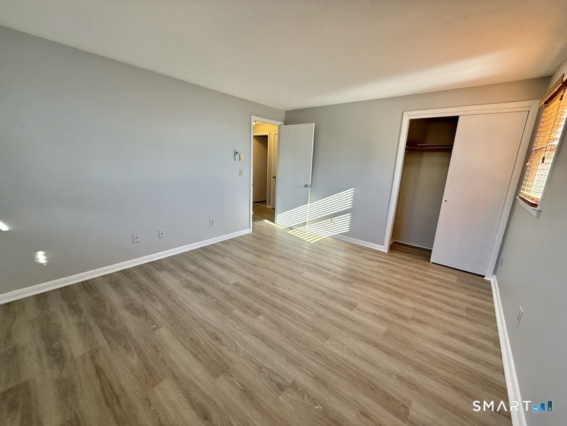 3 Bayview Place, Unit 2 West Haven, CT 06516 - Photo 14 of 19 a view of an empty room with wooden floor and a window