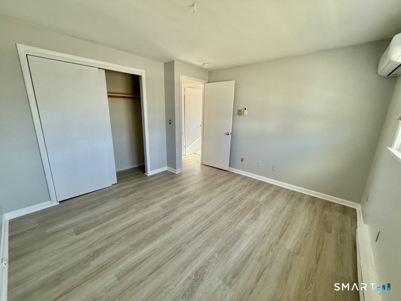 3 Bayview Place, Unit 2 West Haven, CT 06516 - Photo 16 of 19 a view of an empty room with wooden floor