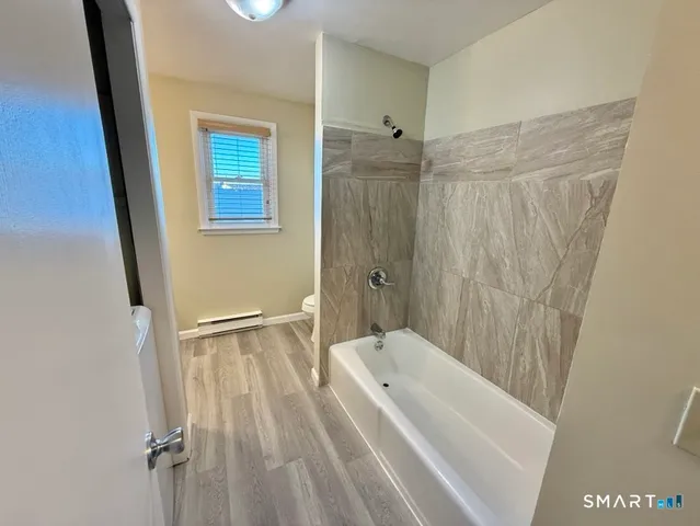 a bathroom with a bathtub and shower