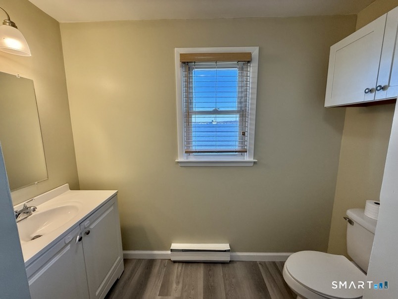 3 Bayview Place, Unit 2 West Haven, CT 06516 - Photo 18 of 19 a bathroom with a sink a toilet and vanity