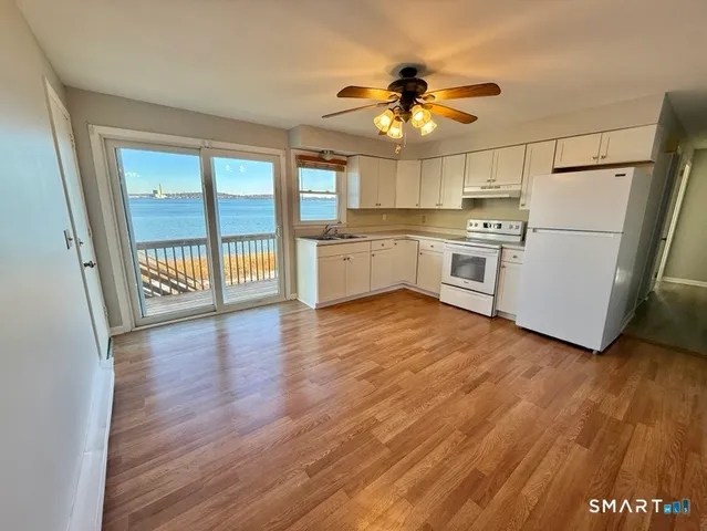 a kitchen with a refrigerator and white cabinets