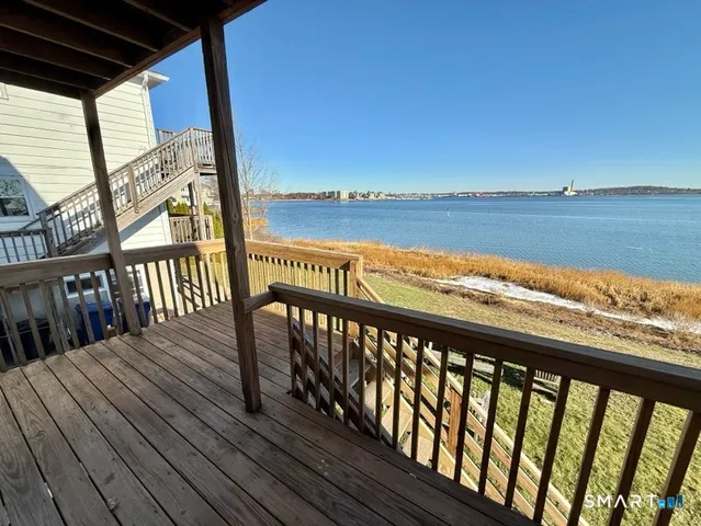 a view of a balcony with wooden floor and outdoor space