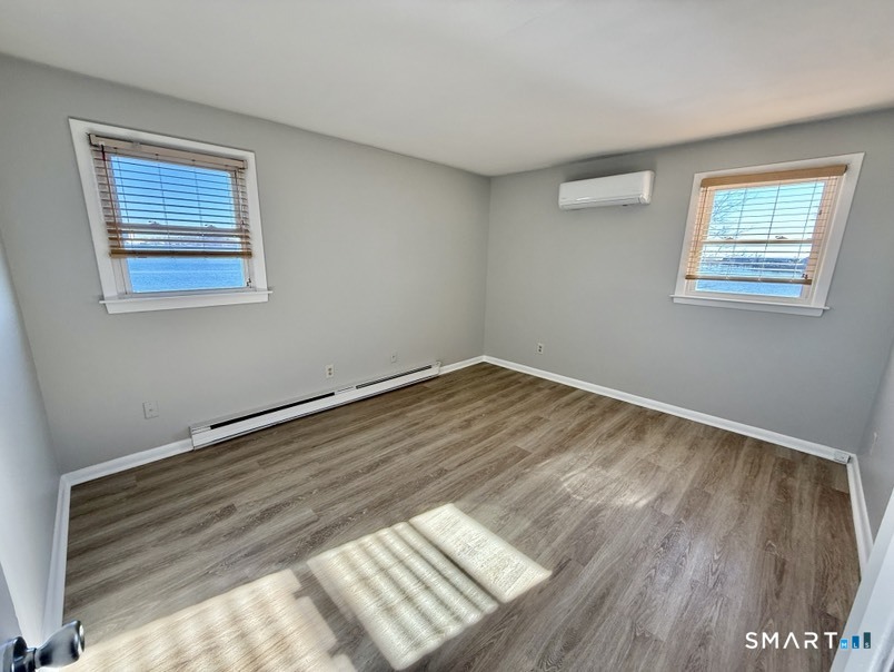 3 Bayview Place, Unit 2 West Haven, CT 06516 - Photo 10 of 19 a view of wooden floor and windows in a room