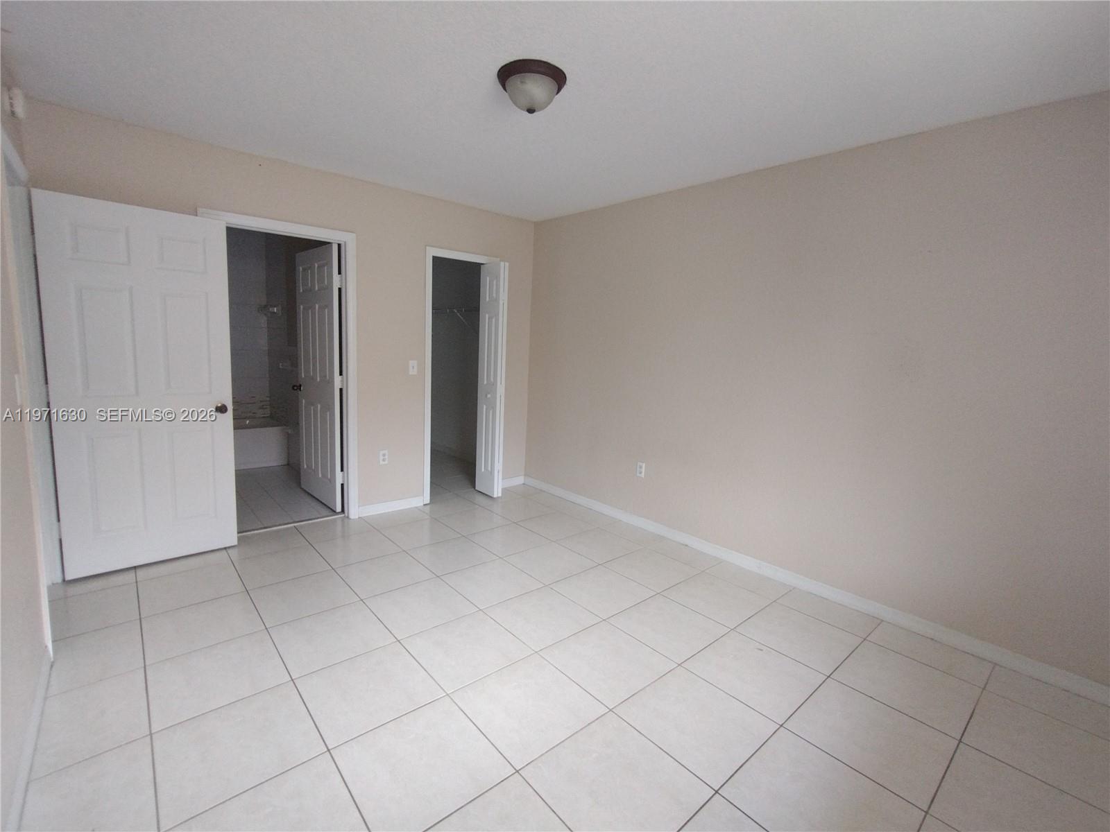 6756 Northwest 182nd Street, Unit 101 Hialeah, FL 33015 - Photo 11 of 29 a view of an empty room and closet area