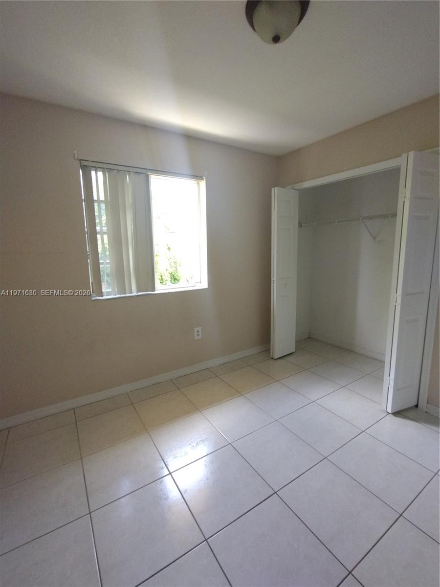 6756 Northwest 182nd Street, Unit 101 Hialeah, FL 33015 - Photo 13 of 29 a view of an empty room with a window