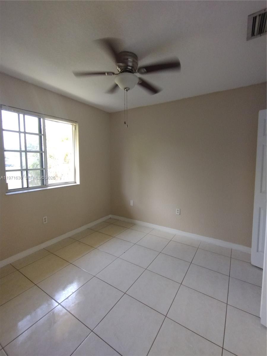 6756 Northwest 182nd Street, Unit 101 Hialeah, FL 33015 - Photo 16 of 29 a view of an empty room with a window