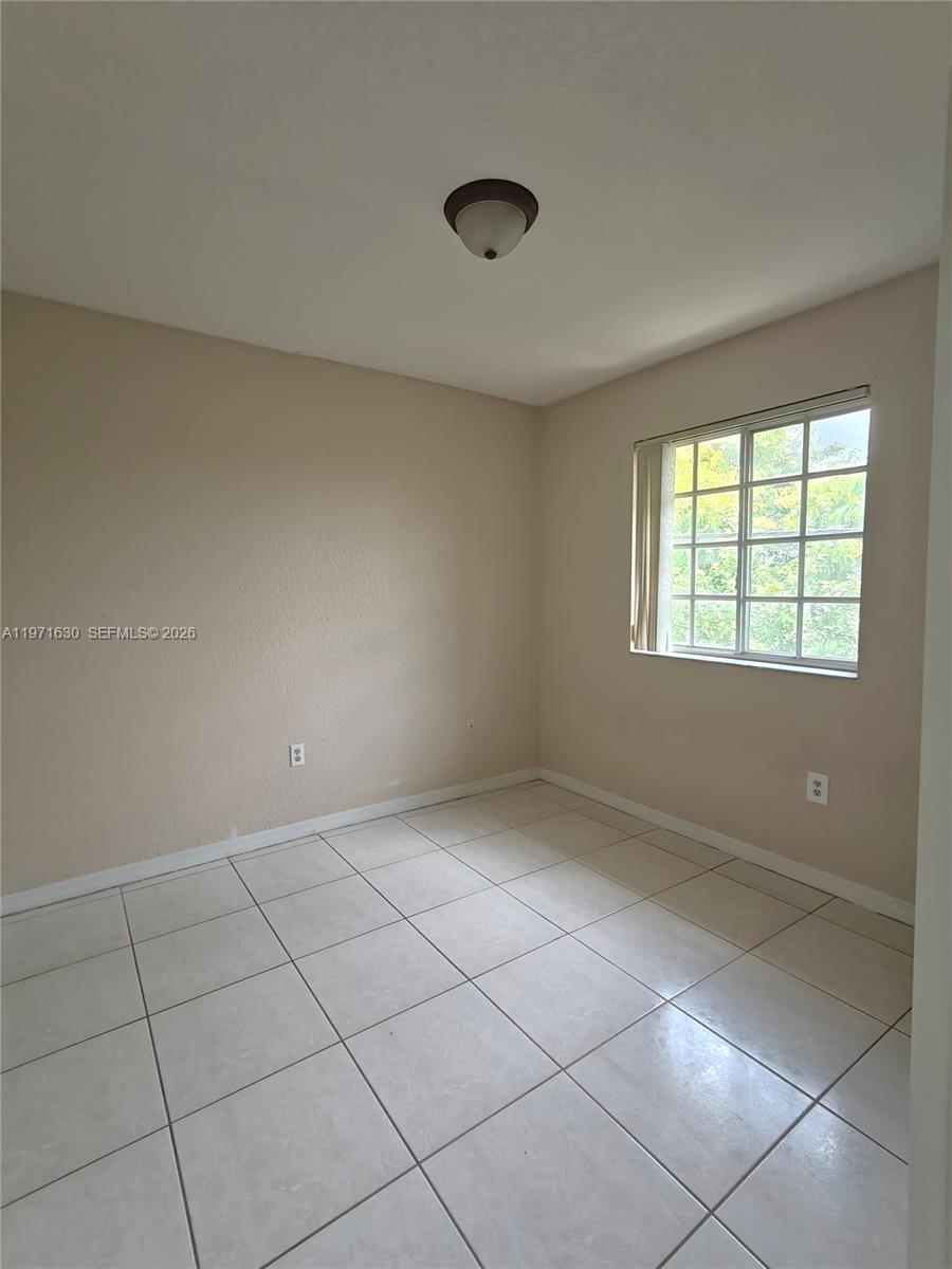 6756 Northwest 182nd Street, Unit 101 Hialeah, FL 33015 - Photo 18 of 29 a view of an empty room with a window