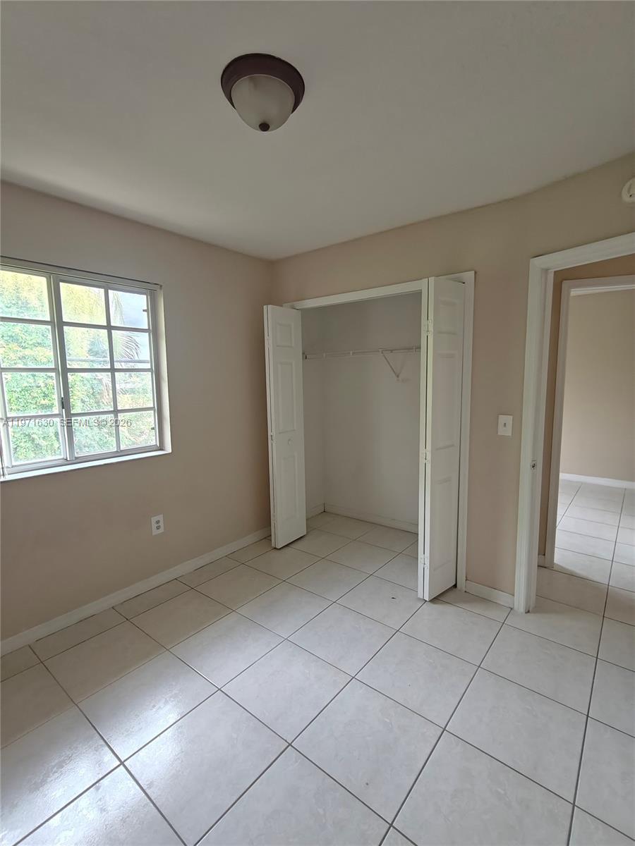 6756 Northwest 182nd Street, Unit 101 Hialeah, FL 33015 - Photo 19 of 29 a view of an empty room with a window