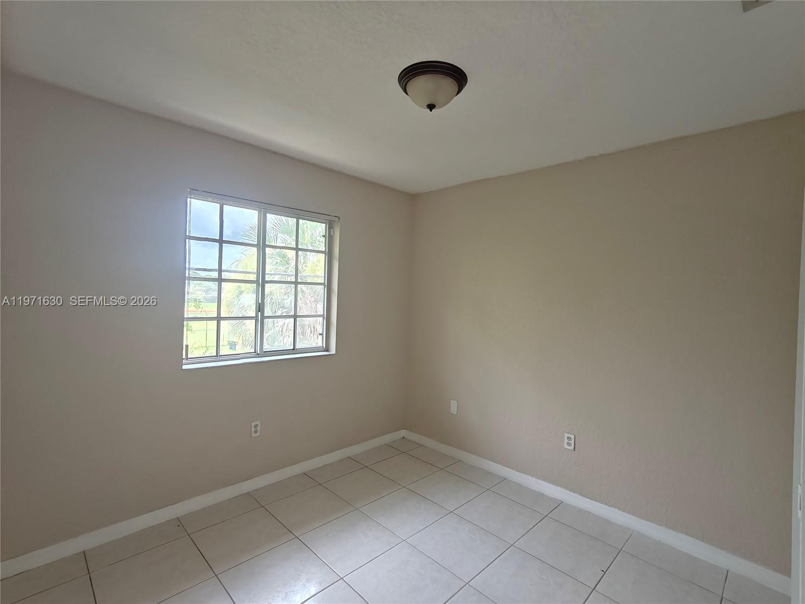 6756 Northwest 182nd Street, Unit 101 Hialeah, FL 33015 - Photo 20 of 29 an empty room with a empty space and windows