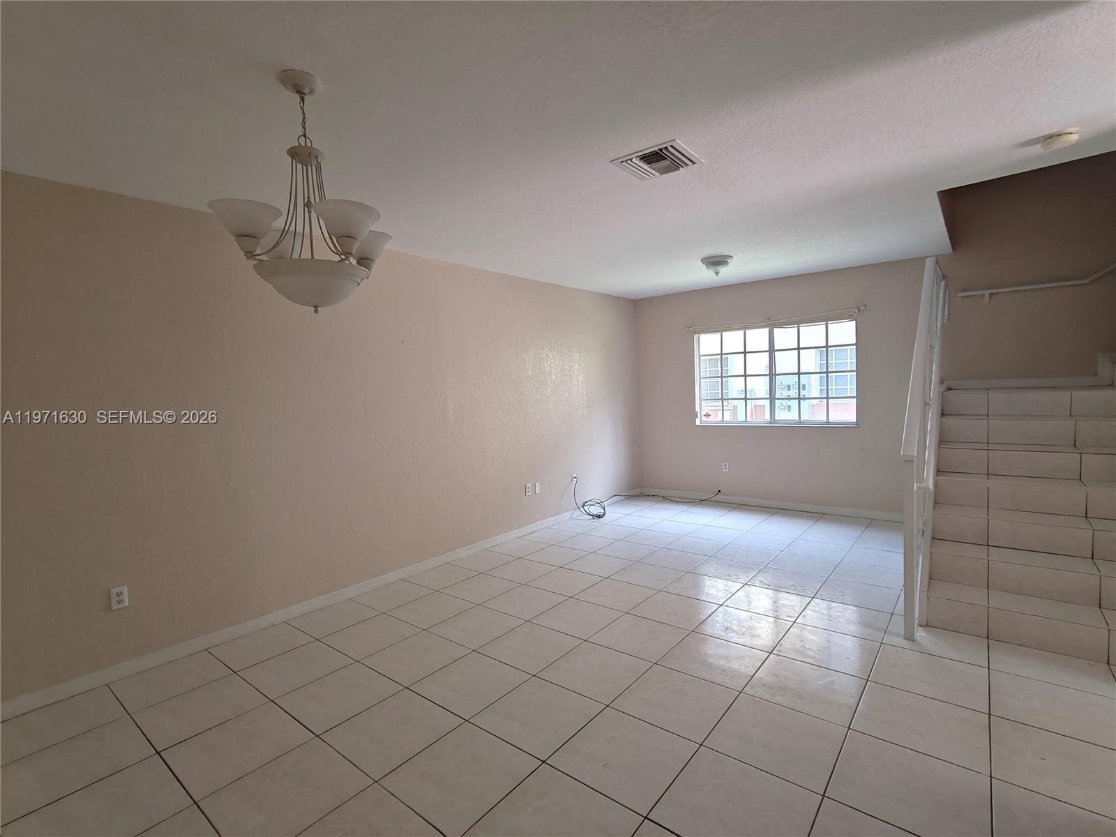 6756 Northwest 182nd Street, Unit 101 Hialeah, FL 33015 - Photo 28 of 29 a view of an empty room with a window